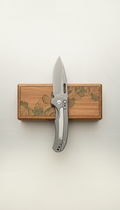 Titanium folding pocket knife with custom-etched box